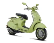 Light green retro-style scooter with a black seat and rounded mirrors.